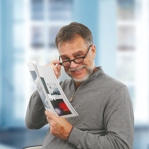 man wearing improvision spectacles reading brochure