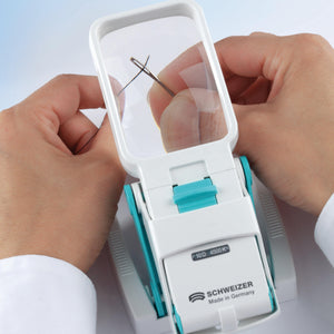okolux stand with magnifier shown threading needle